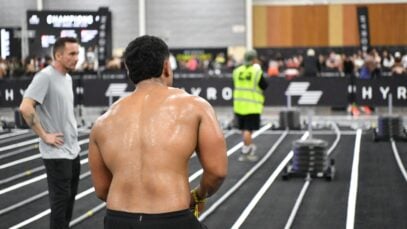 Athlete preparing for intense fitness challenge indoors at a competitive event in Singapore.